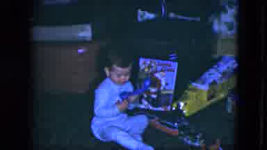 Cleveland Ohio (1951): A Child In Pajamas Playing With A Toy Phone On Christmas