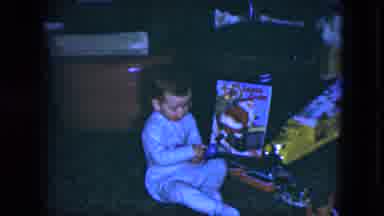 Cleveland Ohio (1951): Little Boy Wearing Pajamas Playing With His Toys On A