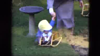 Cleveland Ohio-1951: Toddler Boy In Blue Jacket And Yellow Hat Walking With Woman On Lawn