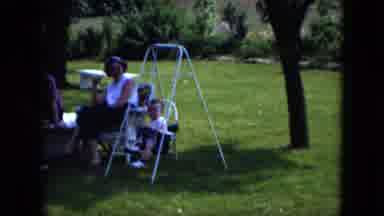 Cleveland Ohio (1951): Baby Jumping On Swingset With A Smile On Face