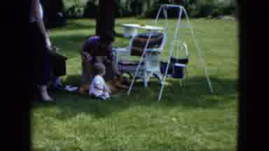 Cleveland Ohio (1951): A Little Kid Playing With A Dog As His Mother Sits Behind