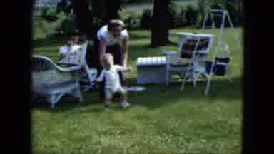 Cleveland Ohio (1951): A Child Is Playing In The Garden With His Mother