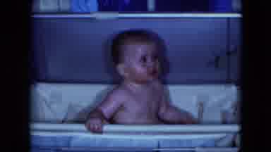 Cleveland Ohio (1951): Baby Sits On White Bassinet Tub Smiling And Looking Around