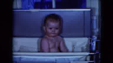 Cleveland Ohio (1951): A Rosy Cheeked Baby Sitting Up And Looking Around In A
