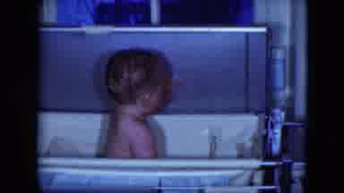 Cleveland Ohio (1951): A Baby Is Sitting In A Crib Looking At The Person Making