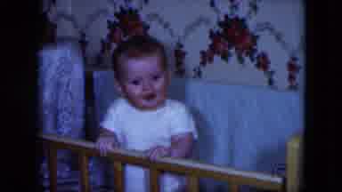 Cleveland Ohio (1951): An Active Baby In A Crib Is Standing And Seems To Seek