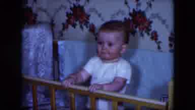 Cleveland Ohio (1951): A Baby In Its Crib Smiling And Pointing At Something