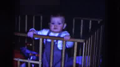 Cleveland Ohio (1951): Baby In And Out Of A Crib Playing With A Toy In Both Hands