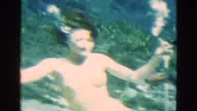 Florida USA (1952): Female Swimmer Takes Air From Oxygen Tube And Paddles