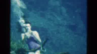 Florida USA (1952): Woman Under The Sea Removes Air Mask To Take A Sip Of Soda
