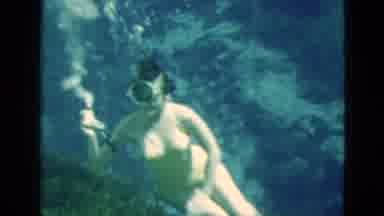 Florida USA (1952): A Woman Sucks Air From A Hose And Swims With Fish Above A