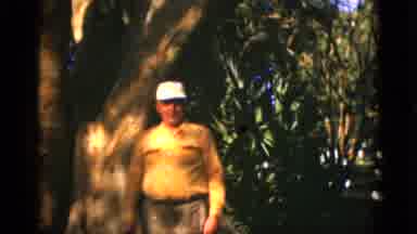 Quebec Canada (1952): Older Man Talking In Front Of Trees On A Breezy Day In