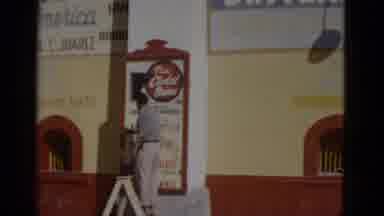 Baja California Mexico (1952): A Man Stands In Front Of A Business Tending To A