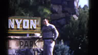 California USA (1952): View Of Mountains And Ocean While Man Stands At Park Sign