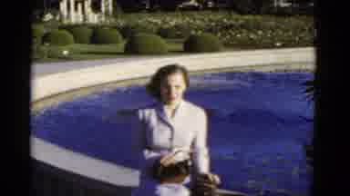 California USA (1952): A Woman In The Garden Sitting Besides The Pool Of Water