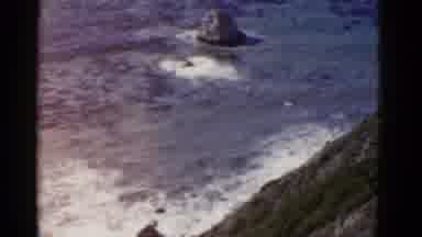 California USA (1952): Birds Eye View Ocean Waves Crashing Into The Face A Steep