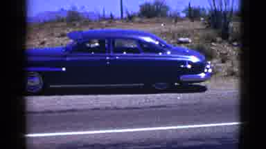 Palm Desert California (1953): Blue Car Road Standing Still Sky Dry White Line