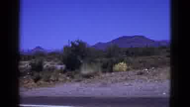 Palm Desert California (1953): A Car Fastly Moving On The Road