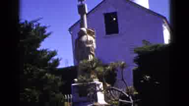 California USA-1953: Two Statues Near Church Including Nautical Ship Sculpture