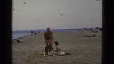 California USA (1953): Man Changes Into Swimsuit On The Beach