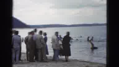 California USA (1953): Crowd Of People Standing By The Beach And Swimmers Wading