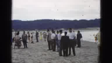 California USA (1953): Well Dressed People Converse In Small Groups At The Beach