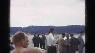 California USA (1953): Man Dries Himself Off With Towel Standing Next To Others On