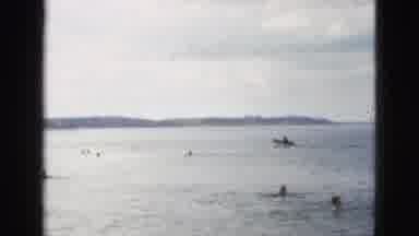 California USA (1953): A Day At The Beach With Kids Playing And A Guy Riding A