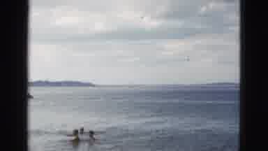 California USA (1953): Group Of Children Swimming In A Large Lake Then A Shot Of