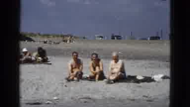 California USA (1953): Two Small Groups Of People Sitting On A Sand Beach In The