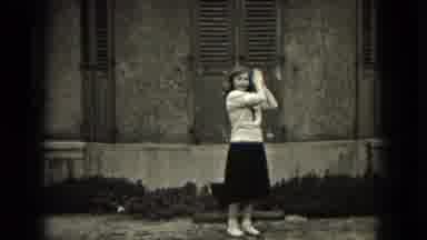 Milwaukee Wisconsin (1953): Young Lady Jumping In Front Of Building With Her