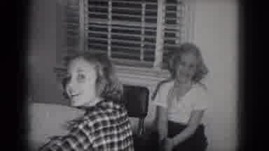 Milwaukee Wisconsin (1953): Woman Sits At Table Tapping Pencil While Girls Sitting