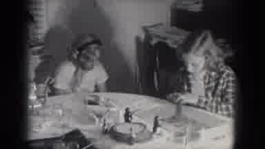 Milwaukee Wisconsin (1953): Young Girls Play Together As The Sit Around The Table