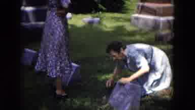 Milwaukee Wisconsin (1953): Old Woman Cleaning And Fixing The Grave