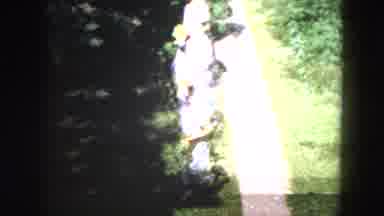 Milwaukee Wisconsin (1953): Woman In A Dress Carries A Yellow Basket And