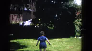 Milwaukee Wisconsin-1953: A Boy Playing In The Backyard Running Towards The Camera