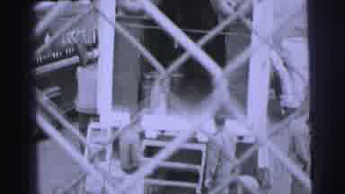 Le Mans France (1954): Man Walking Down Stairs With A Flag And Men Unloading A