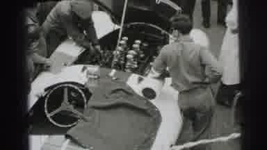 Le Mans France (1954): Small Group Of Men Working Under The Hood Of A Car At The