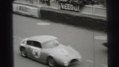 Le Mans France (1954): Spectators Pack The Stands Watching Race Cars Speed Past On