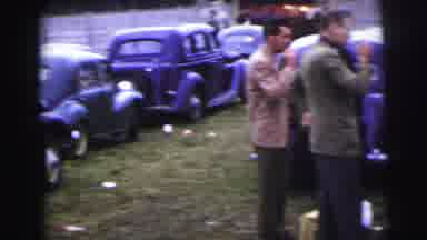 Le Mans France (1954): Vintage Cars Parked Along A Curb At A Car Show