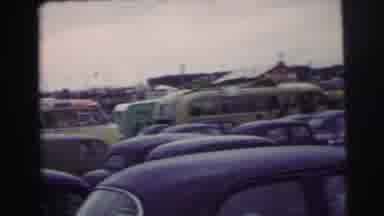 Le Mans France (1954): Spectators In Crowd Watch Race Cars Going Around Curve On