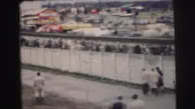 Le Mans France (1954): Large Crowd Of People Gathered And Walking Next To A Fence