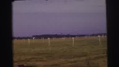Le Mans France-1954: Medium Sized White Passenger Plane Taxiing On Grass Airfield