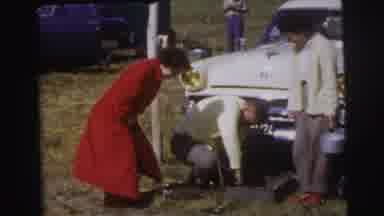 Le Mans France (1954): Man Takes Out Something From The Box While Woman Looking At