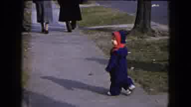 Hicksville New York-1954: Small Child Strolls Along The Sidewalk Quietly On A Winter Day