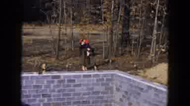 Hicksville New York (1954): Woman Wearing Brown Coat With Red Hat Carries Child
