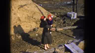 Hicksville New York (1954): A Woman Outside Holding Onto A Baby With A Hat