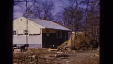 Hicksville New York (1954): Woman Rides Brown Horse Away From Blue Building On A
