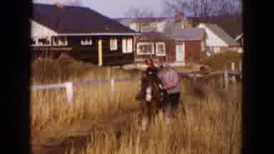 Hicksville New York (1954): A Woman Dressed In Winter Clothing Walks Next To A