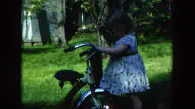 Hicksville New York (1954): A Small Child Is Playing With A Bicycle And Holding